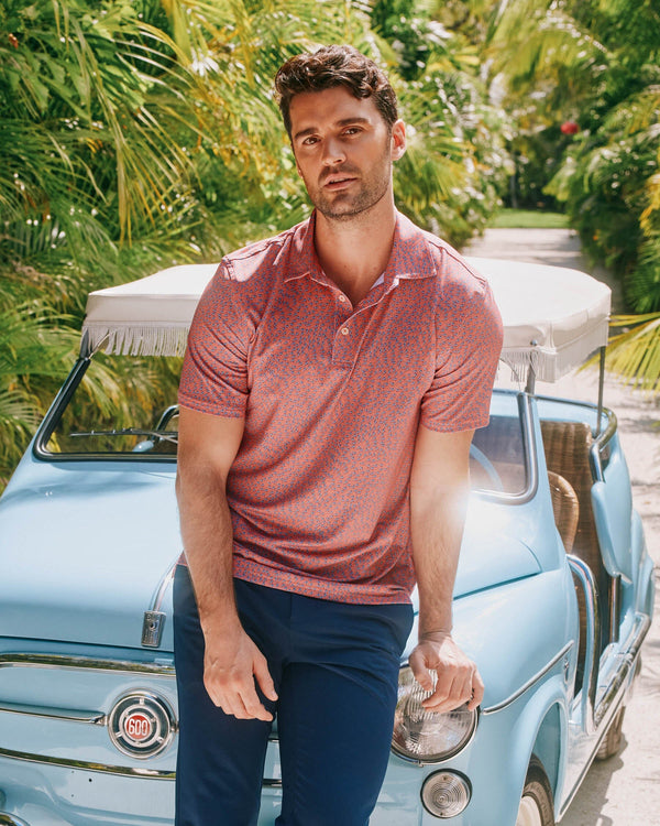 The lifestyle view of the Southern Tide Driver Stay in Schools Polo Shirt by Southern Tide - Rosewood Red