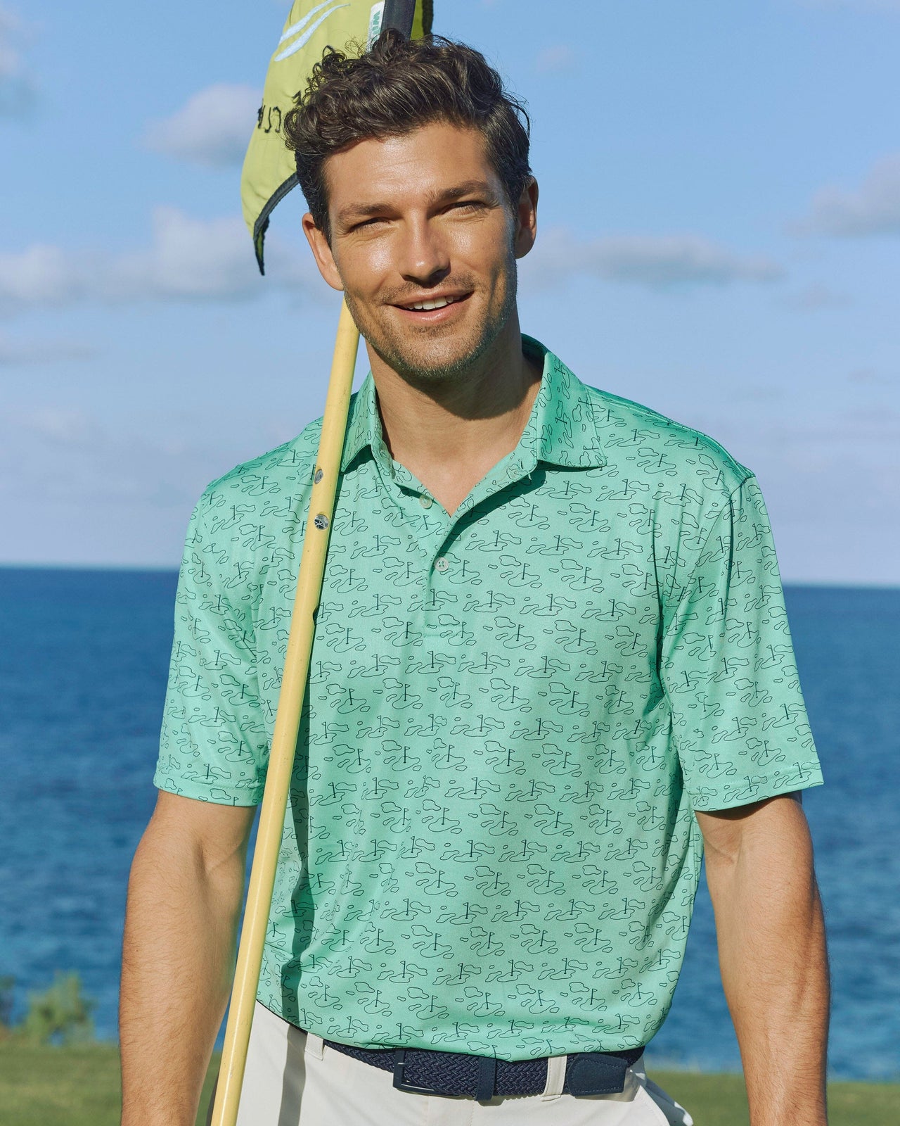 The lifestyle view of the Southern Tide Driver Who's Your Caddy Polo by Southern Tide - Jade Green