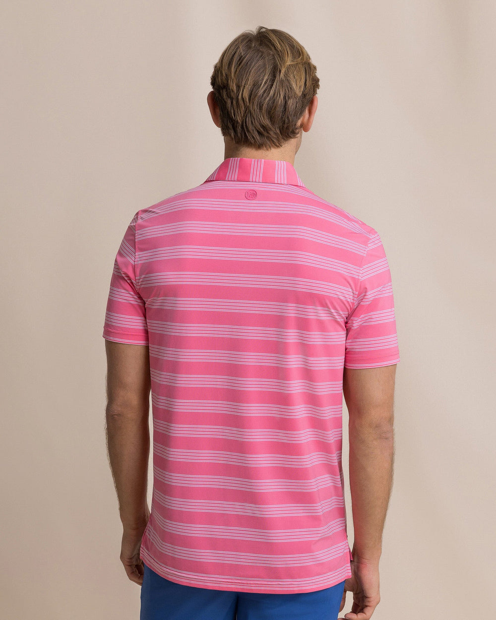 The back view of the Southern Tide Dune Crest Stripe Coastal Breeze® Performance Polo by Southern Tide - Island Pink