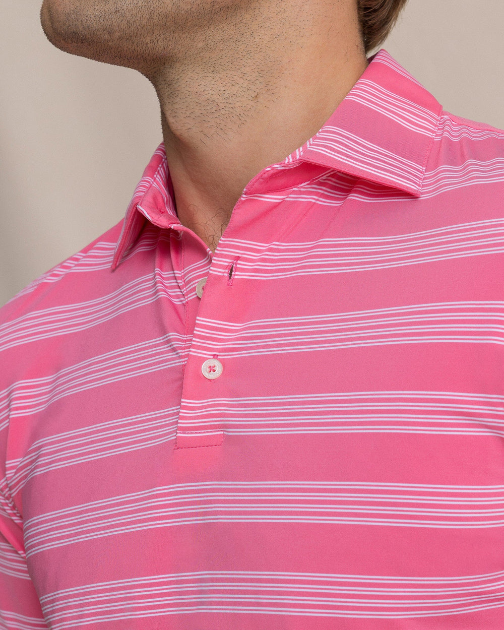 The detail view of the Southern Tide Dune Crest Stripe Coastal Breeze® Performance Polo by Southern Tide - Island Pink