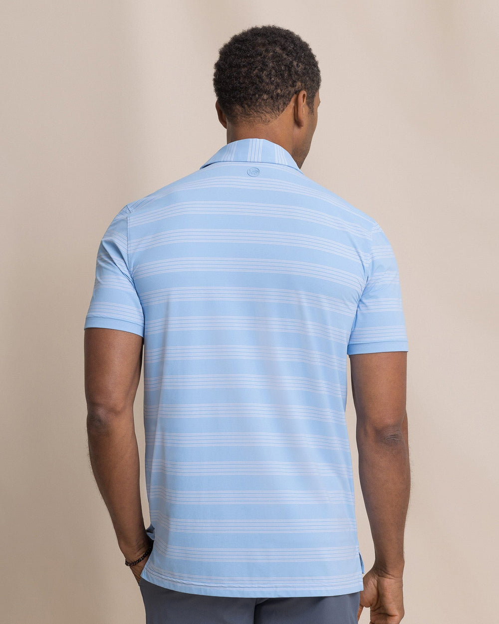 The back view of the Southern Tide Dune Crest Stripe Coastal Breeze® Performance Polo by Southern Tide - Tide Blue