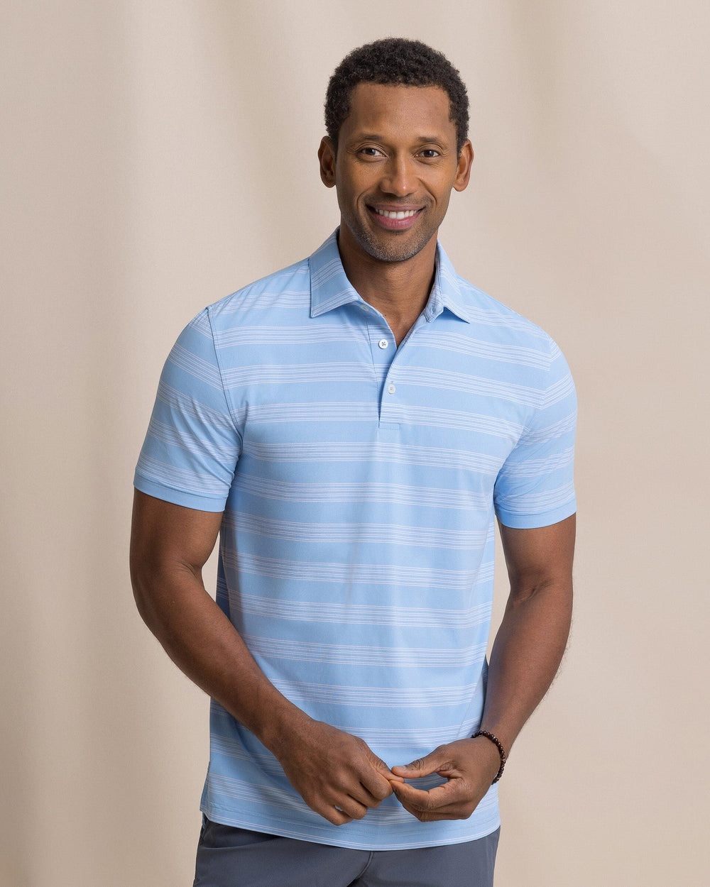 The front view of the Southern Tide Dune Crest Stripe Coastal Breeze® Performance Polo by Southern Tide - Tide Blue