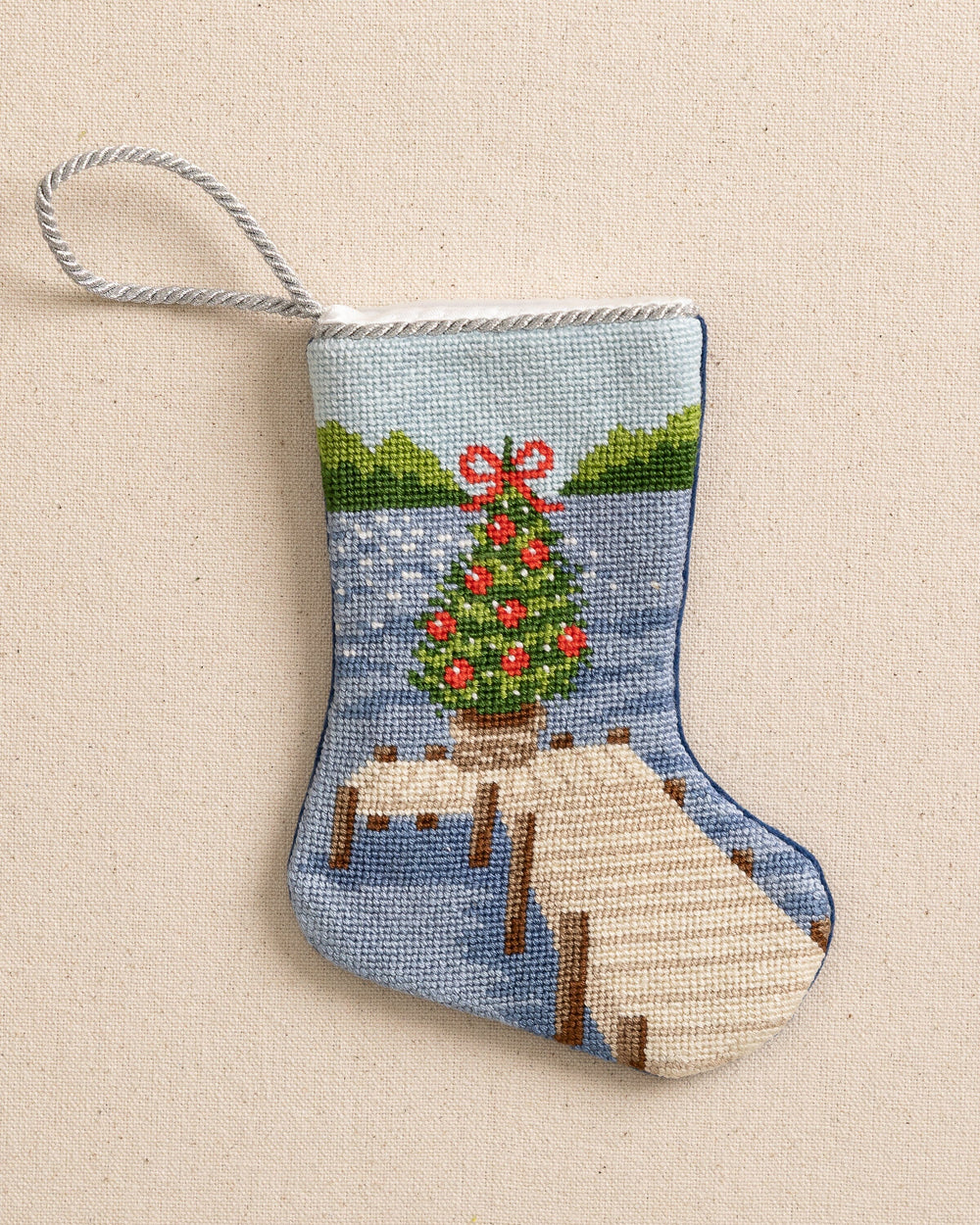 The front view of the Southern Tide Festive Fir Needlepoint Stocking by Southern Tide - Blue