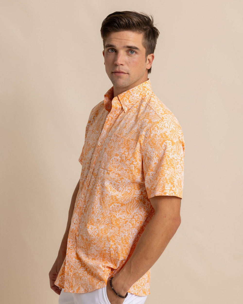The front view of the Southern Tide Floral Coral Intercoastal Short Sleeve Sport Shirt by Southern Tide - Tangerine Orange