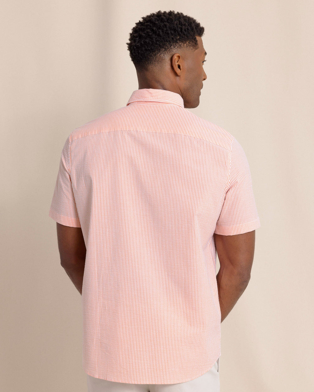 The back view of the Southern Tide Folly Field Stripe Seersucker Short Sleeve Sport Shirt by Southern Tide - Celosia Orange