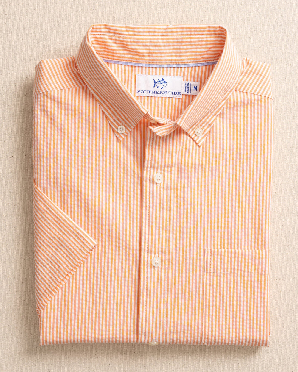 The front view of the Southern Tide Folly Field Stripe Seersucker Short Sleeve Sport Shirt by Southern Tide - Celosia Orange