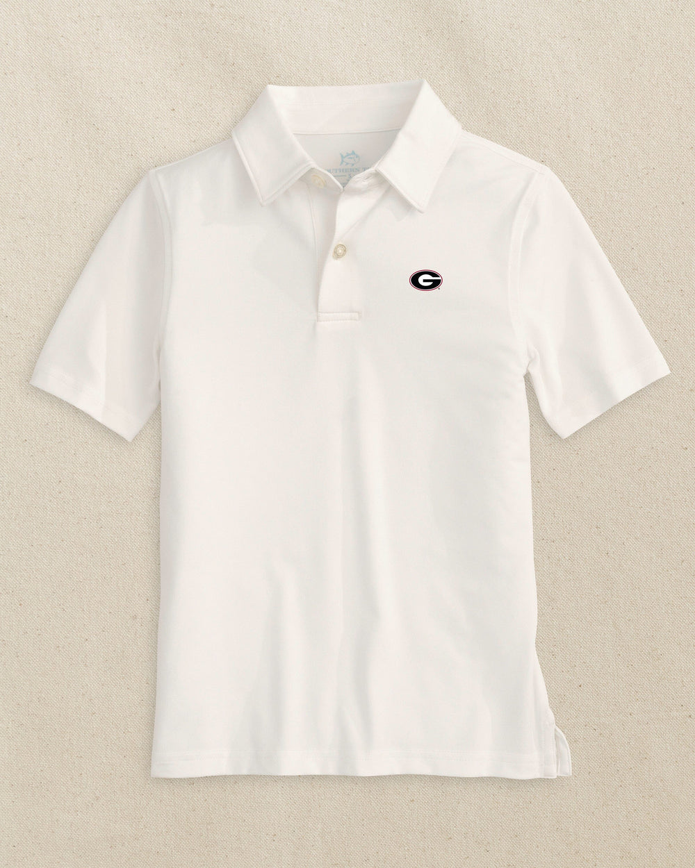 The front view of the Southern Tide Georgia Bulldogs Oval G Boys Driver Performance Polo Shirt by Southern Tide - Classic White