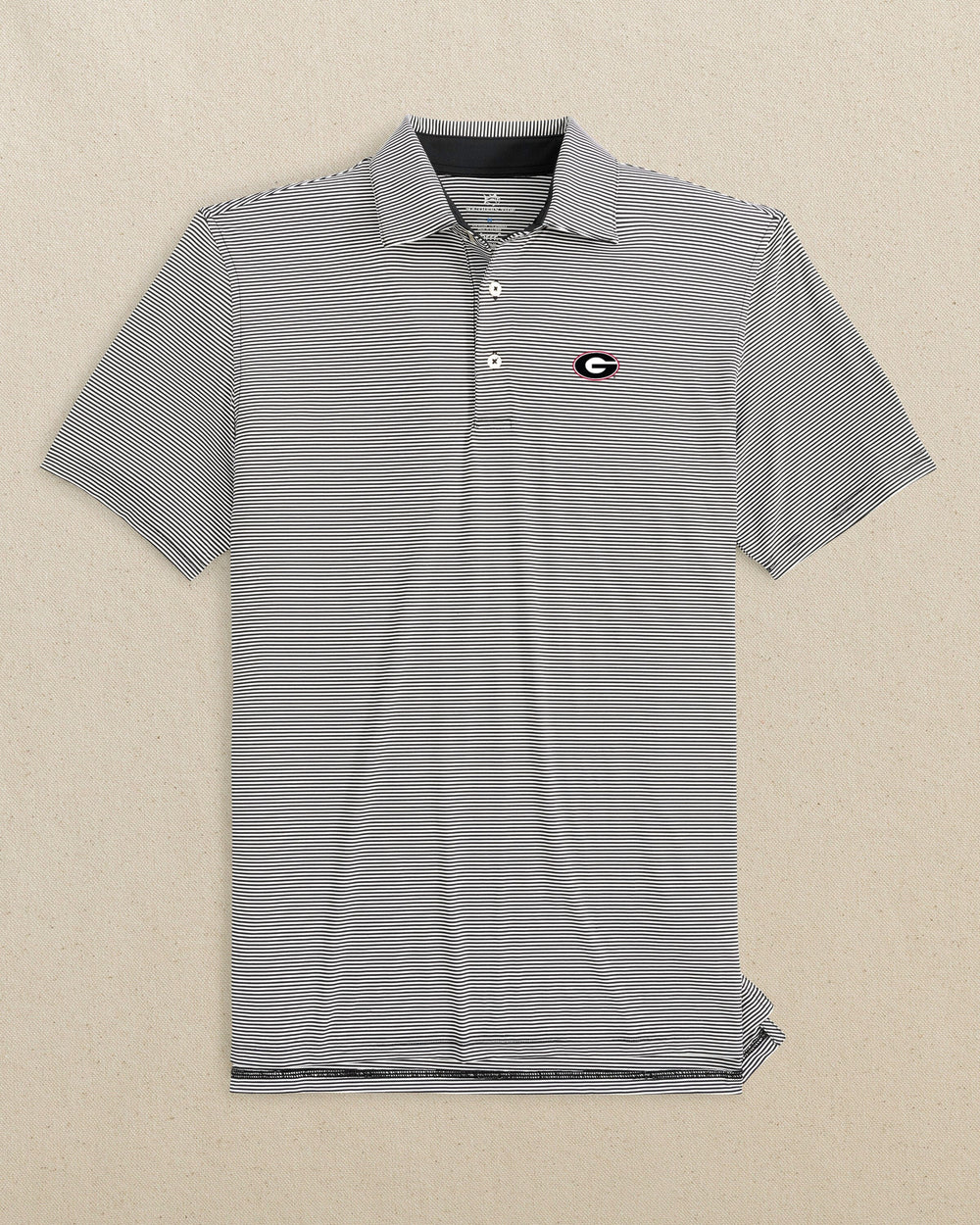 The front view of the Southern Tide Georgia Bulldogs Oval G brrr°®-eeze Meadowbrook Stripe Polo by Southern Tide - Caviar Black