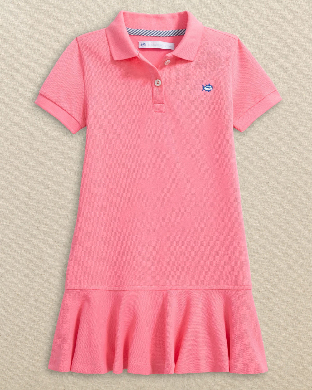 The front view of the Southern Tide Girls Skipjack Dropwaist Polo Dress by Southern Tide - Sea Pink