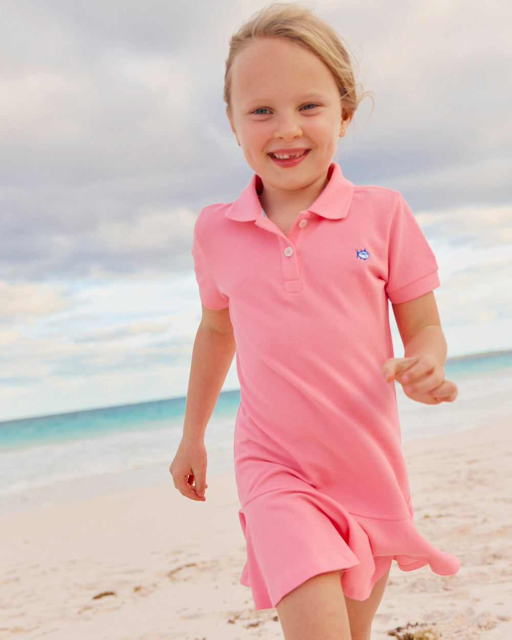 The lifestyle view of the Southern Tide Girls Skipjack Dropwaist Polo Dress by Southern Tide - Sea Pink