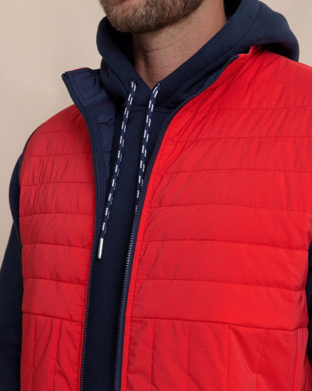 The detail view of the Southern Tide Greenwood Packable Quilted Vest by Southern Tide - Crab Red