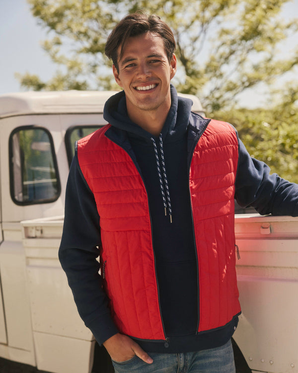 The lifestyle view of the Southern Tide Greenwood Packable Quilted Vest by Southern Tide - Crab Red