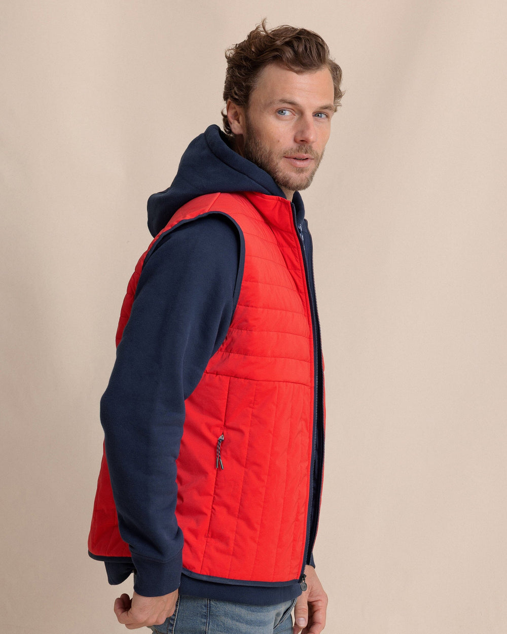 The side view of the Southern Tide Greenwood Packable Quilted Vest by Southern Tide - Crab Red