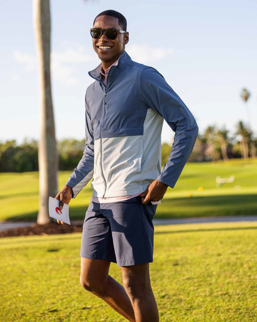 The model lifestyle view of the Men's Gulf 8 Inch Brrr Performance Short by Southern Tide - True Navy