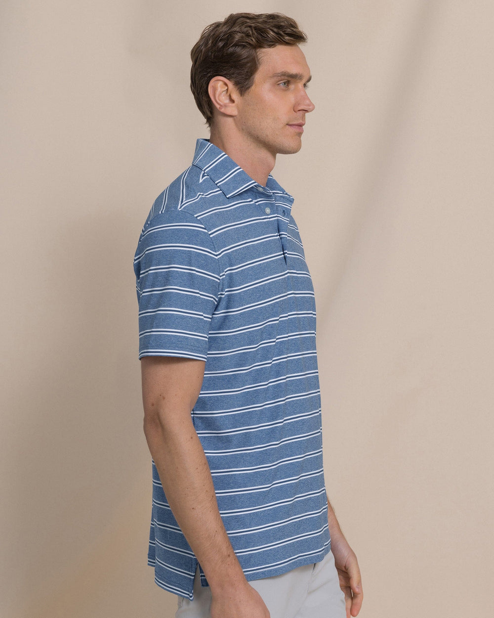 The side view of the Southern Tide Heather Stripe Coastal Breeze® Performance Polo by Southern Tide - Heather Nautical Blue