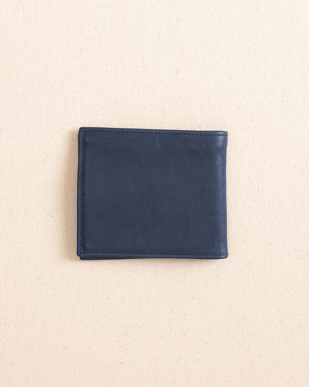 The back view of the Il Bisonte Classic Bifold Wallet at Southern Tide - Blue Mezzanotte