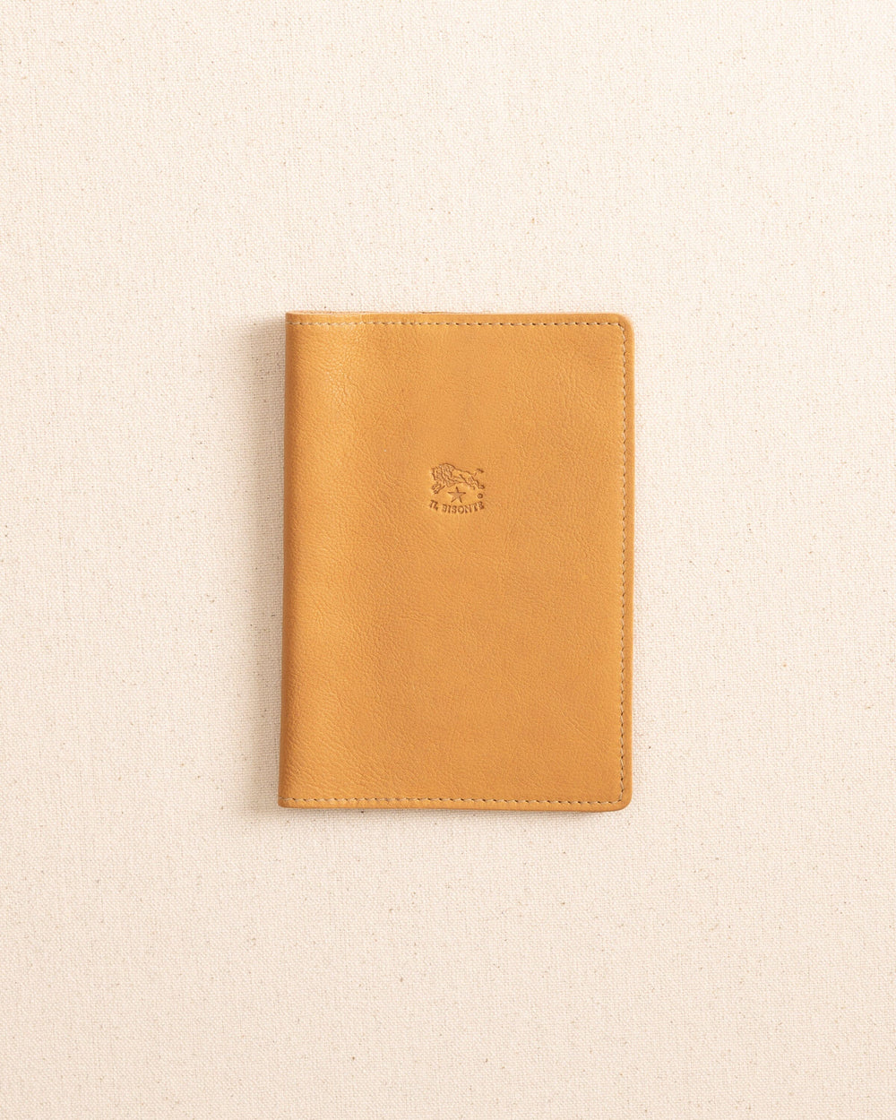 The front view of the Il Bisonte Passport Case at Southern Tide - Natural