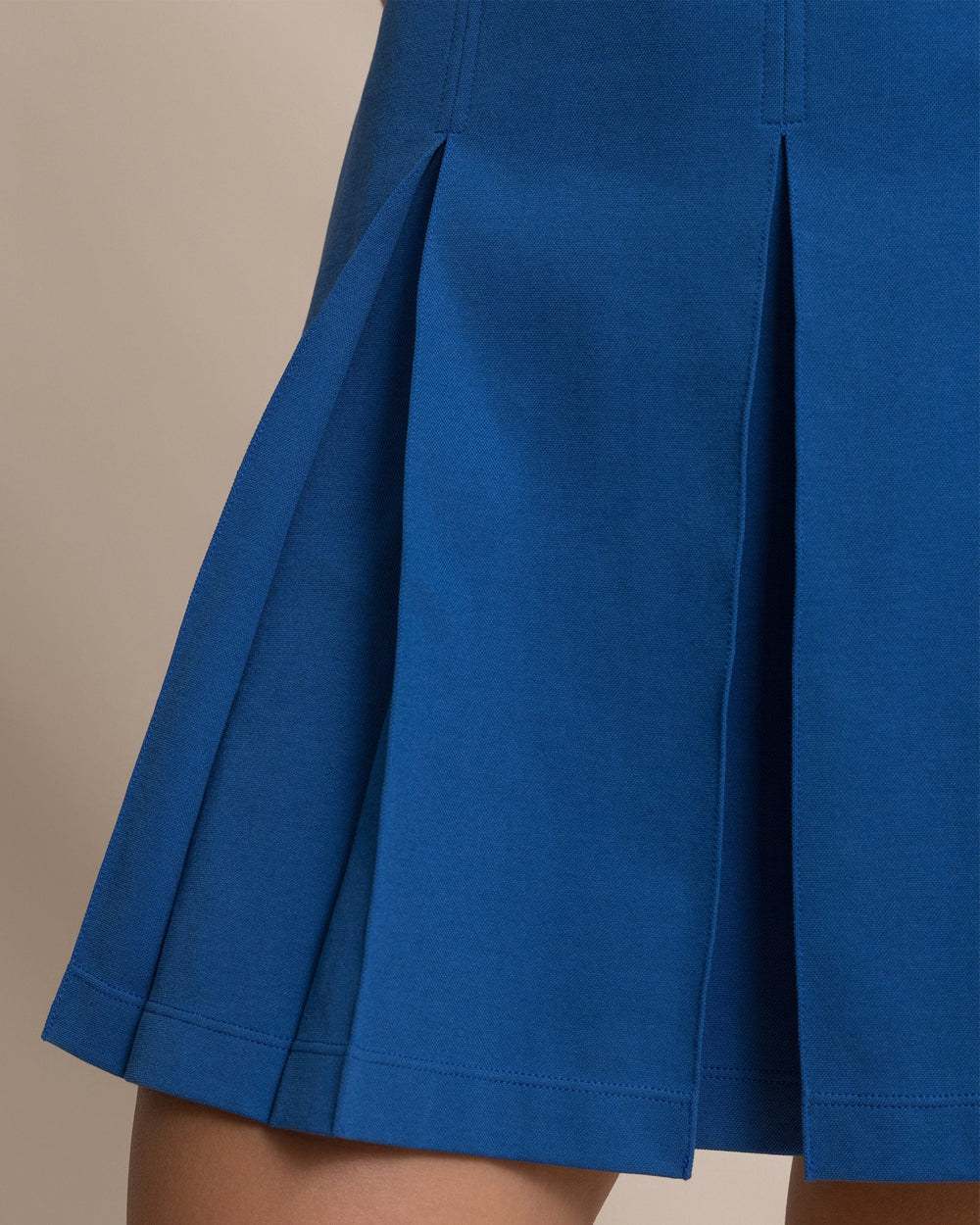 The detail view of the Southern Tide Isabelle Solid Polo Active Dress by Southern Tide - Nautical Blue