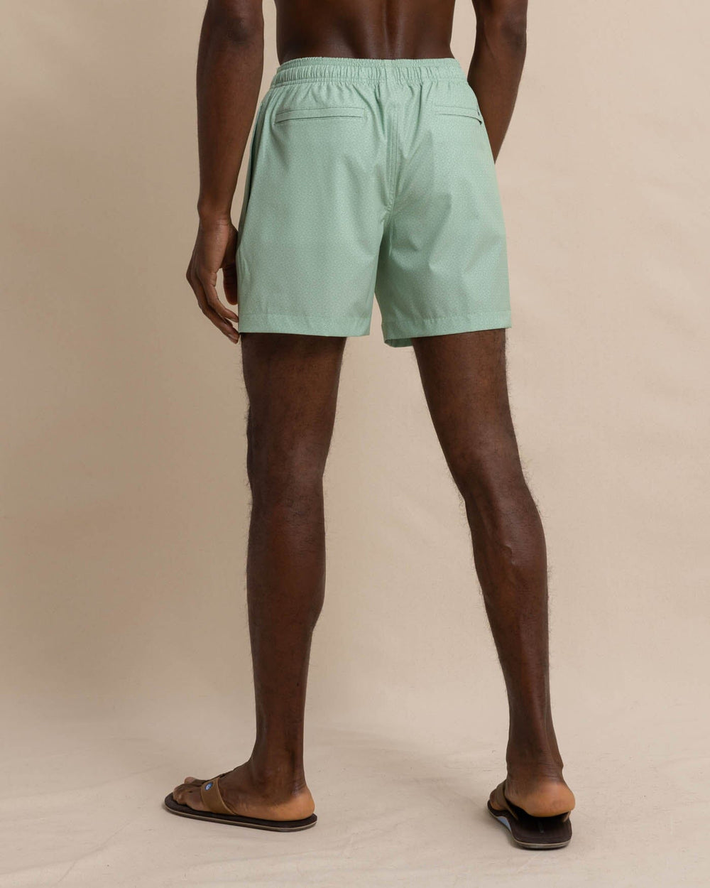 The back view of the Southern Tide It's Wavey Baby Swim Trunk by Southern Tide - Basil Green