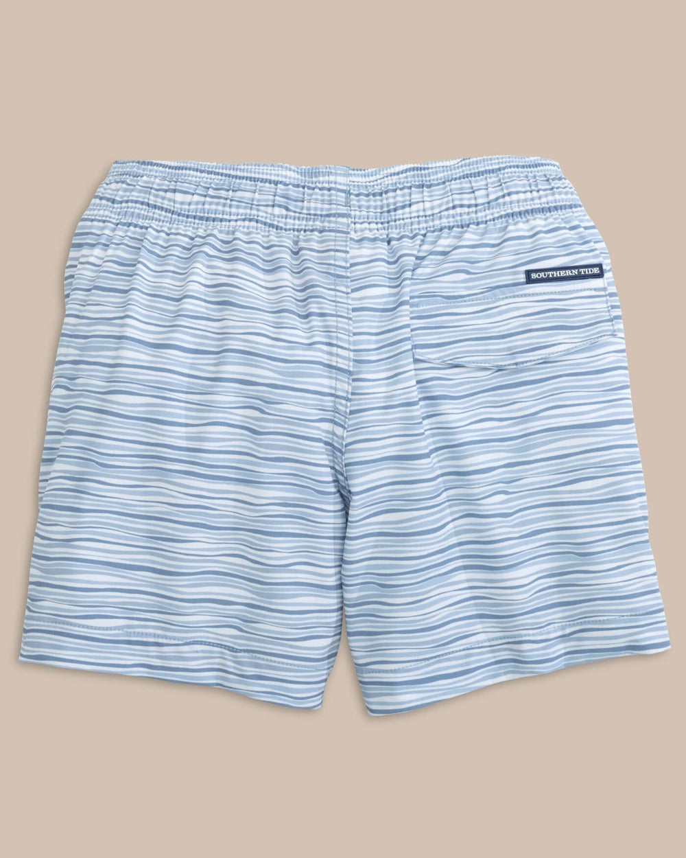 The back view of the Southern Tide Kids Ocean Water Stripe Swim Trunk by Southern Tide - Subdued Blue
