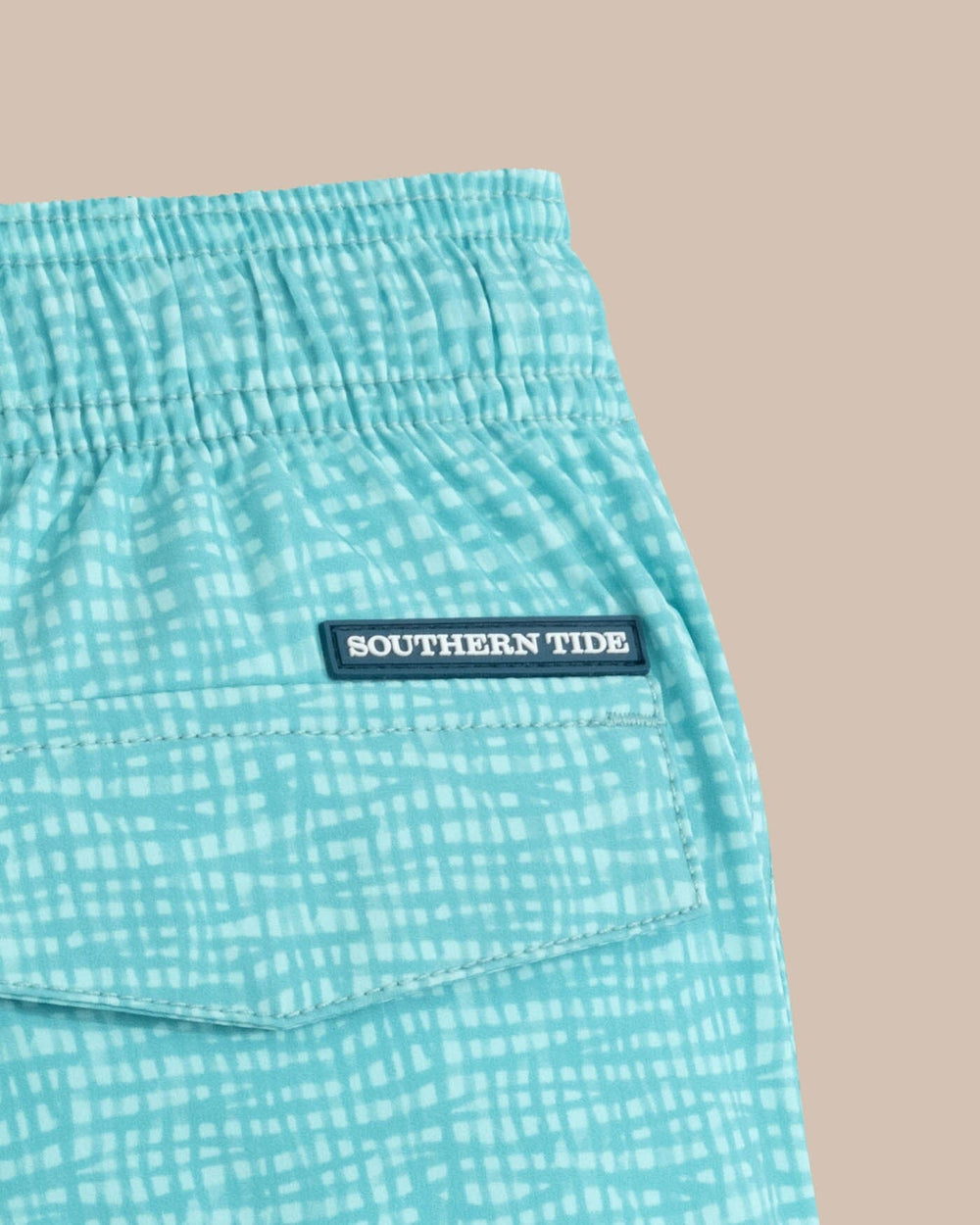 The detail view of the Southern Tide Kids Painted Check Swim Trunk by Southern Tide - Wake Blue