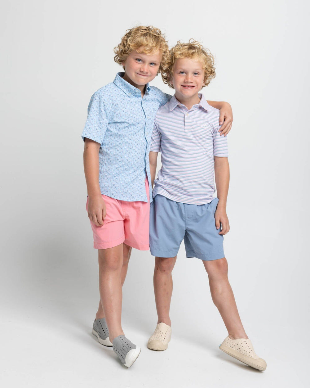 The front view of the Southern Tide Kids Ryder Heather Halls Stripe Performance Polo by Southern Tide - Heather Pale Rosette Pink