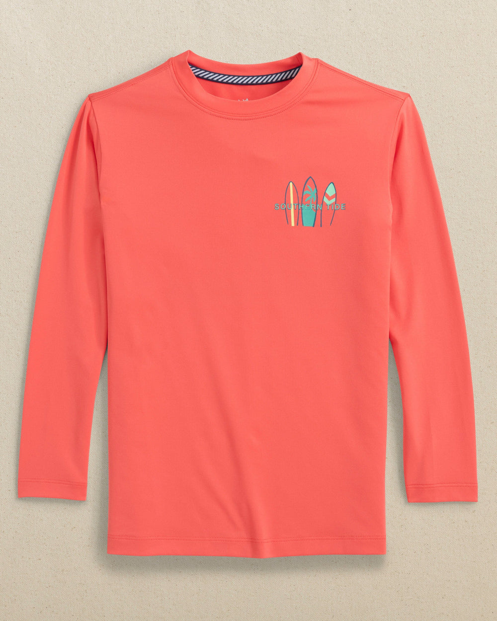 The front view of the Southern Tide Kids Surfing Stripes Long Sleeve Performance T-Shirt by Southern Tide - Sunset Coral