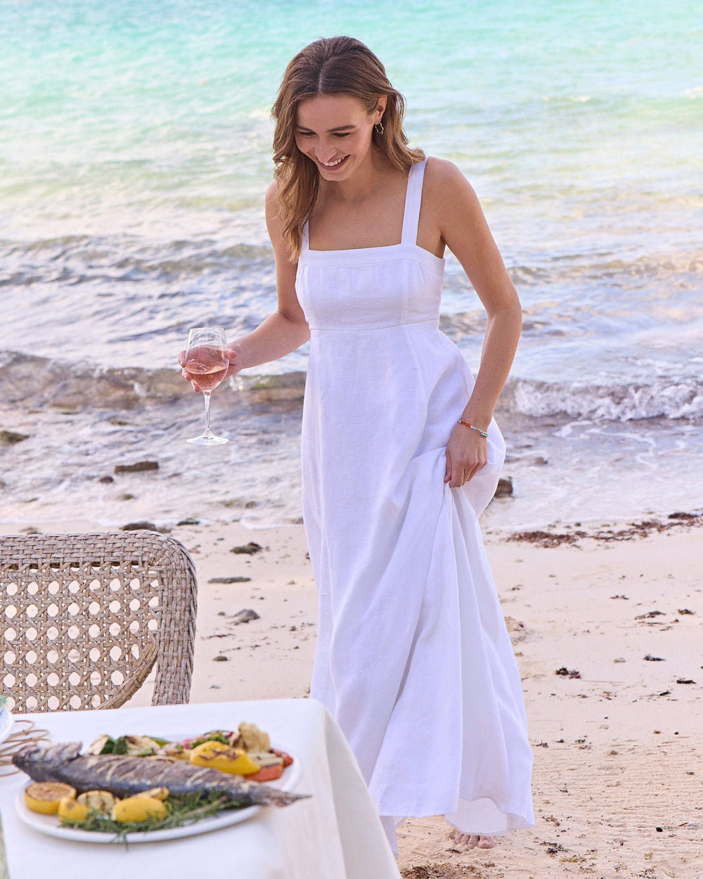 The lifestyle view of the Southern Tide Leighton Linen Tie Back Maxi Dress by Southern Tide - Classic White