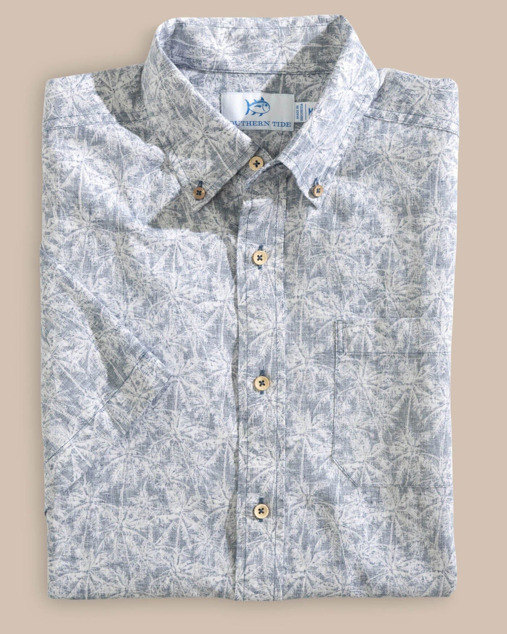 The folded view of the Southern Tide Linen Rayon Keep Palm and Carry On Print Sport Shirt by Southern Tide - Aged Denim