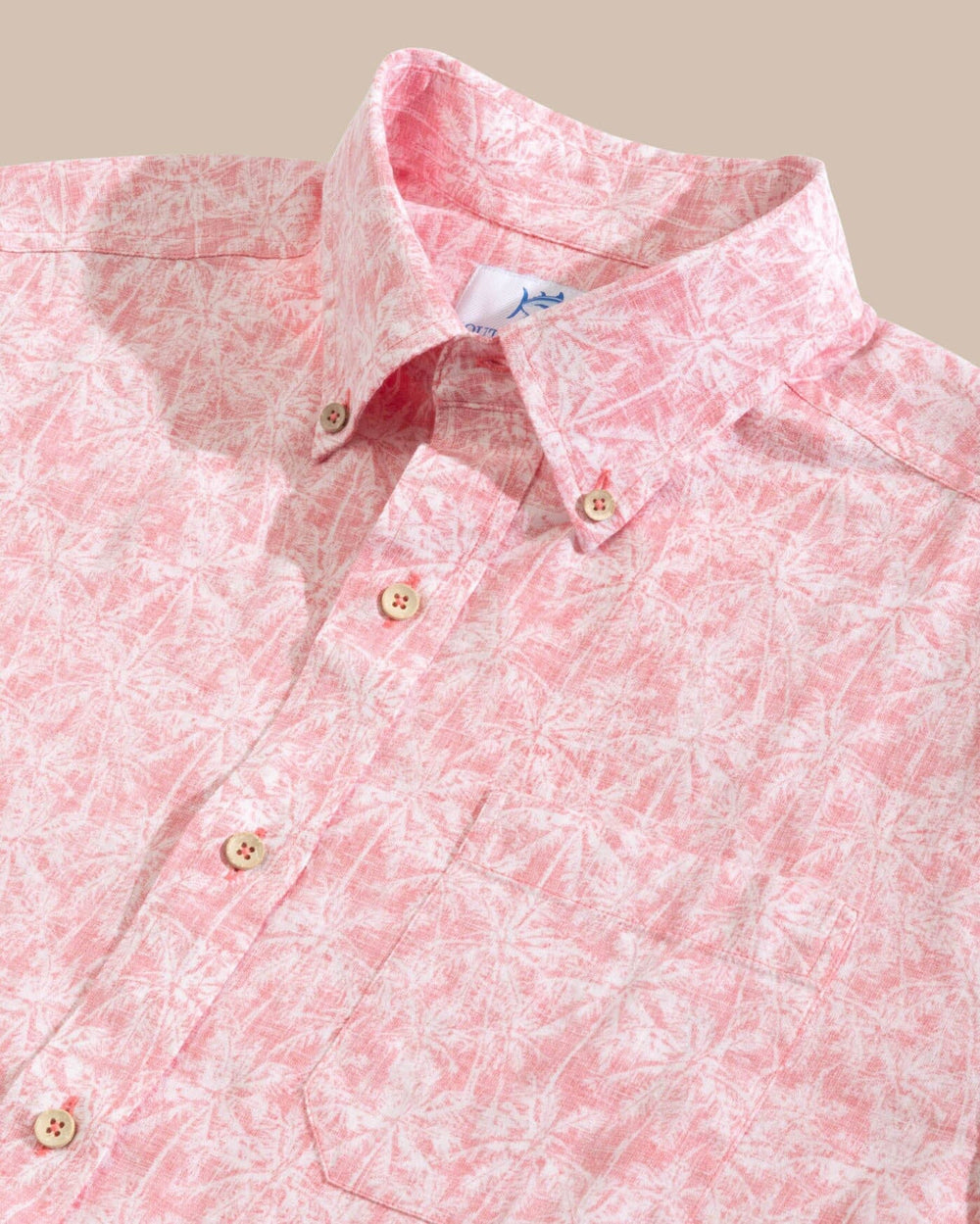The detail view of the Southern Tide Linen Rayon Keep Palm and Carry On Print Sport Shirt by Southern Tide - Rosewood Red