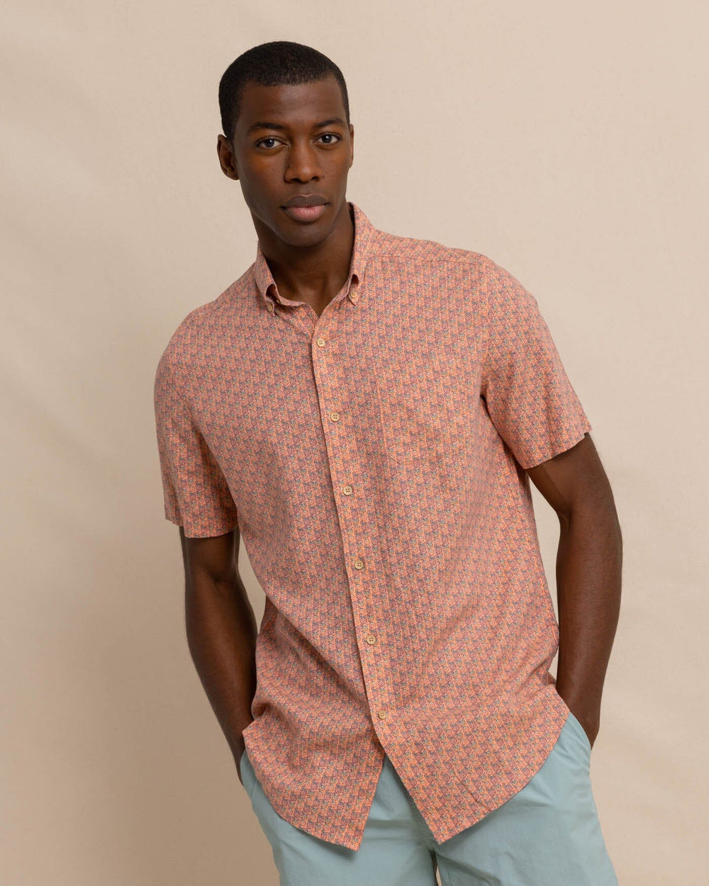The front view of the Southern Tide Linen Rayon Vacation Views Short Sleeve SportShirt by Southern Tide - Desert Flower Coral