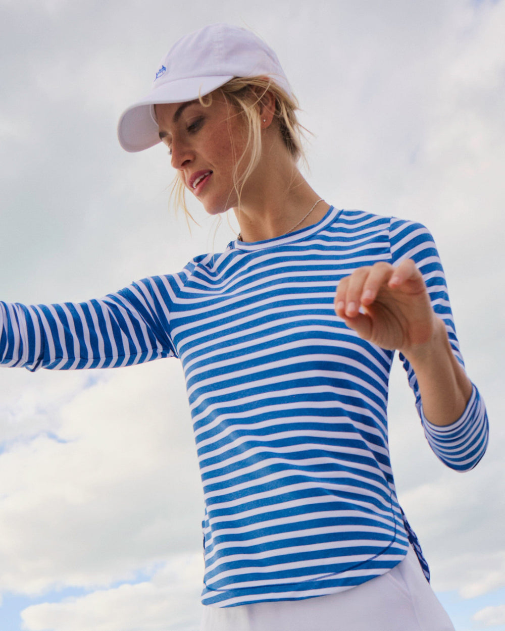 The lifestyle view of the Southern Tide Linley Stripe Coastal Breeze® Performance Crew by Southern Tide - Nautical Blue