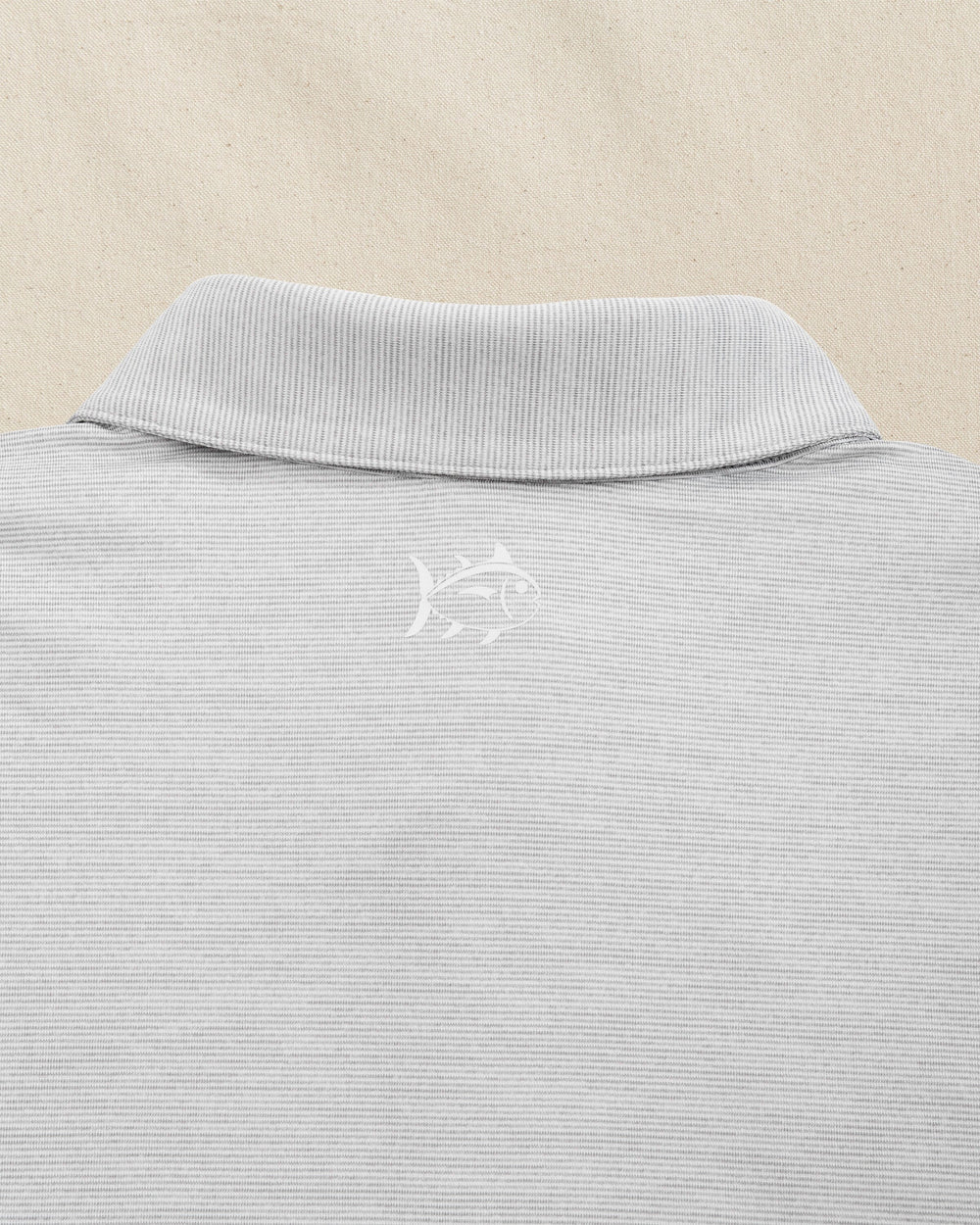 The detail view of the Southern Tide Louisville Cardinals Driver Spacedye Polo by Southern Tide - Slate Grey