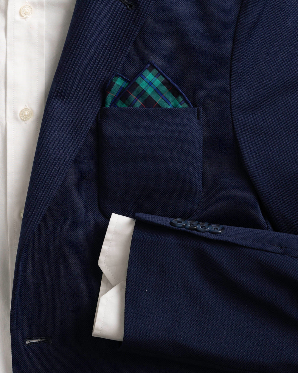 The detail coat view of the High Cotton Macleod Tartan Pocket Square at Southern Tide - Blue