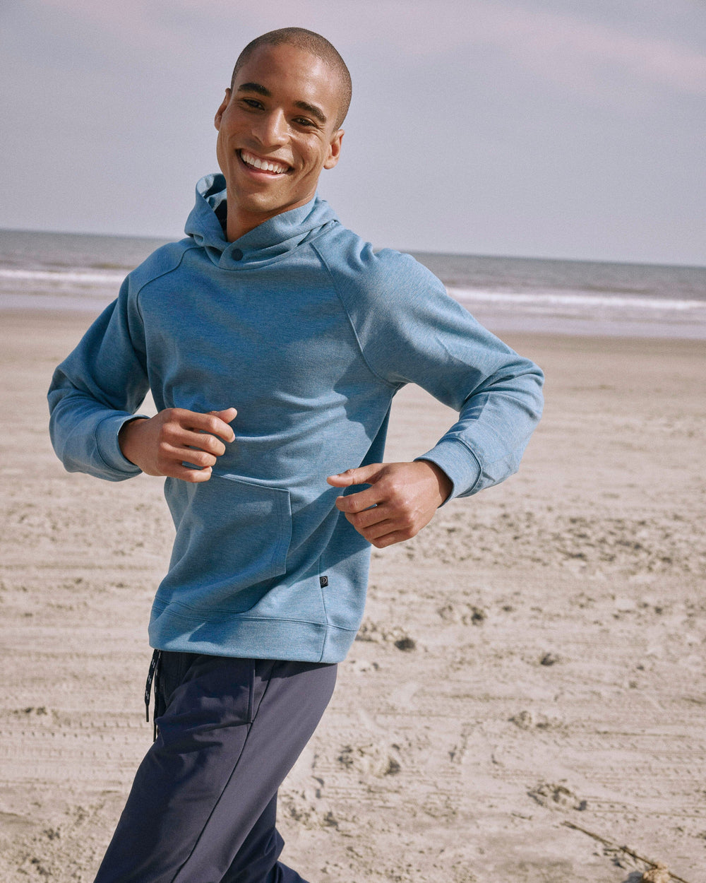 The lifestyle view of the Southern Tide Manteo Heather Interlock Snapfront Hoodie by Southern Tide - Heather Teal Haze