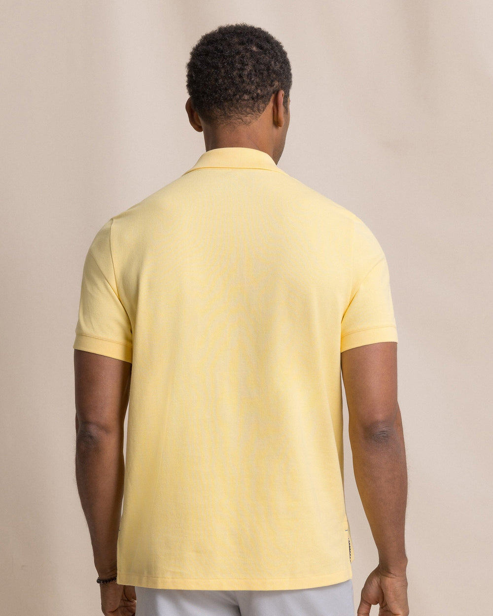 The back view of the Southern Tide Skipjack Polo Shirt by Southern Tide - Pineapple