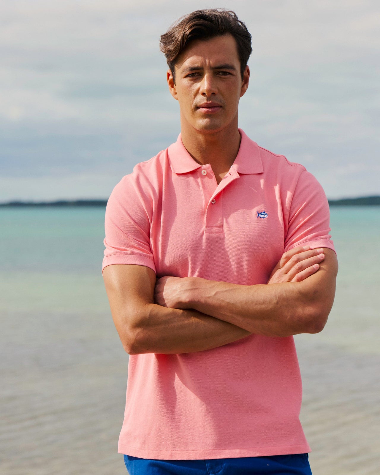 The lifestyle view of the Southern Tide Skipjack Polo Shirt by Southern Tide - Sea Pink