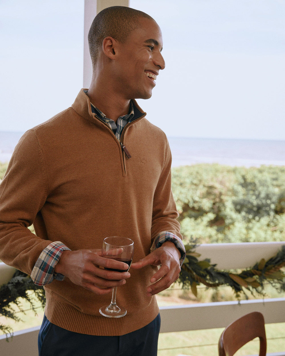 The lifestyle view of the Southern Tide Oakatie Heather Quarter Zip Sweater by Southern Tide - Heather Hazelnut Khaki