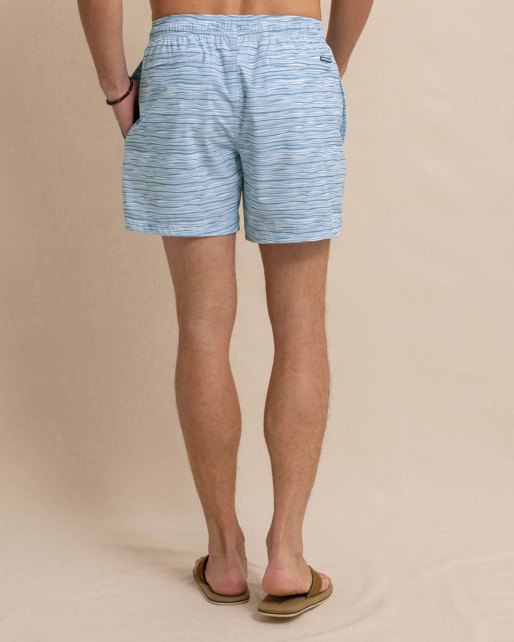 The back view of the Southern Tide Ocean Water Stripe Swim Trunk by Southern Tide - Subdued Blue