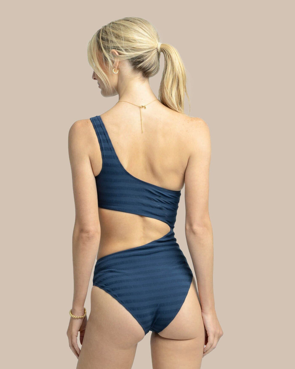 The back view of the Texture One Shoulder One-Piece by Southern Tide - Dress Blue