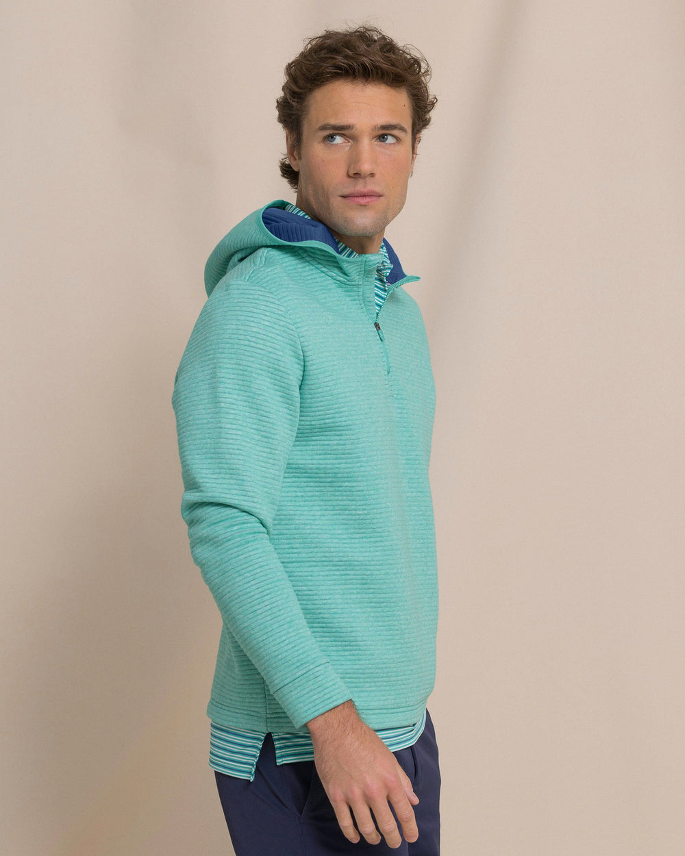 The side view of the Southern Tide Ottoman Heather Quarter Zip Hoodie by Southern Tide - Heather Persian Green