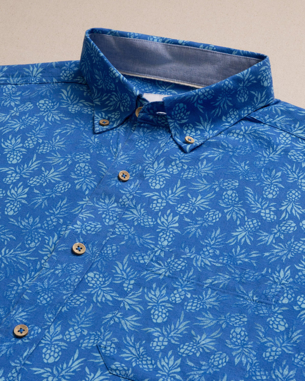 The detail view of the Southern Tide Pineapple Parade Linen Rayon Short Sleeve Sport Shirt by Southern Tide - Blue Stream
