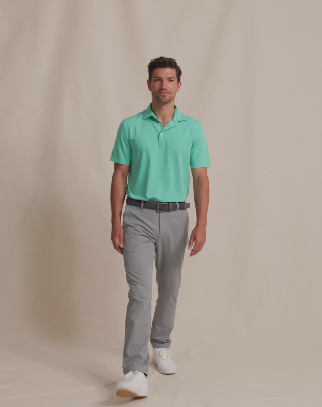The runway view of the Southern Tide brrr°®-eeze Heather Performance Polo Shirt by Southern Tide - Heather Turtle Green