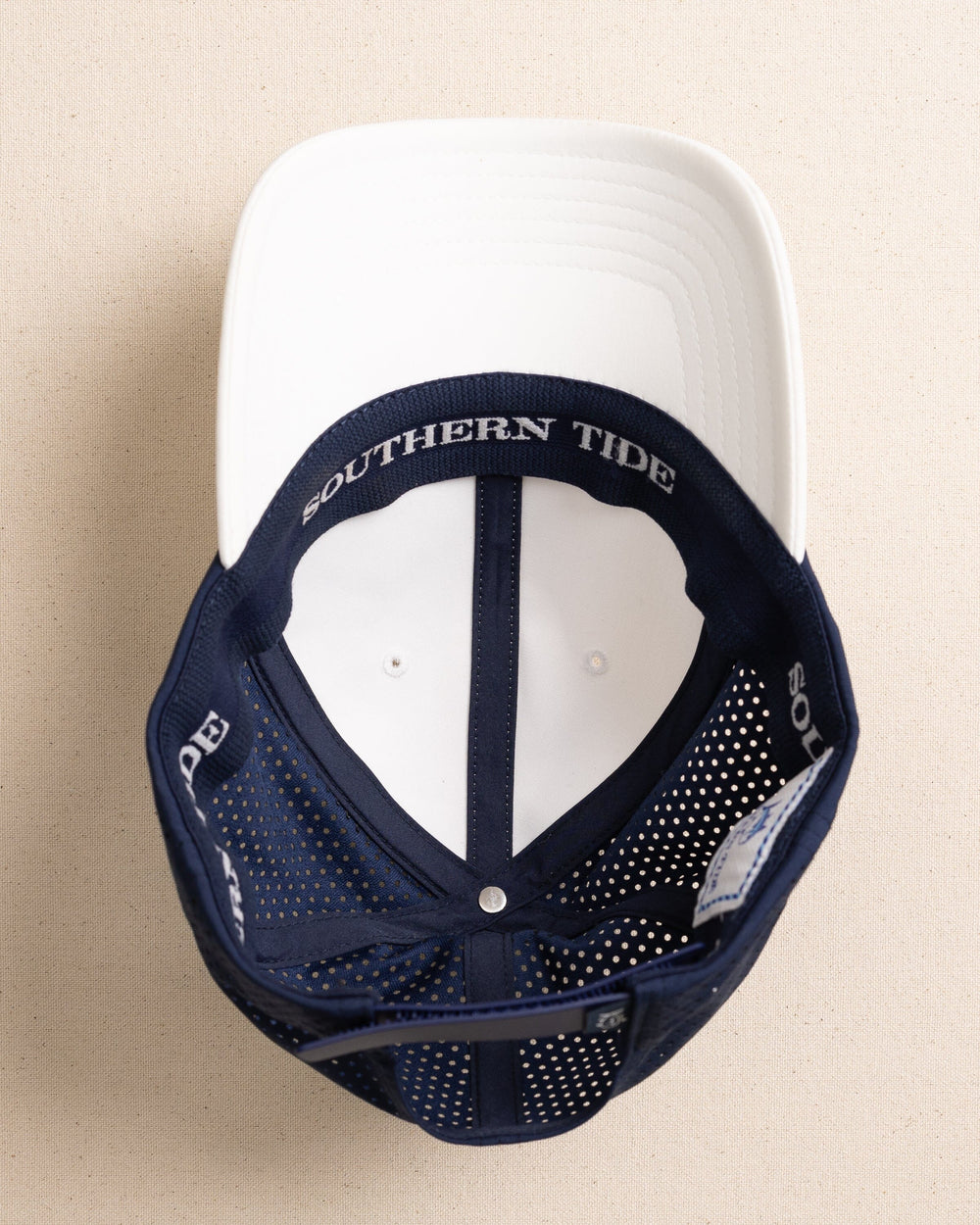 The under view of the Southern Tide Salty Snapback Performance Hat by Southern Tide - White