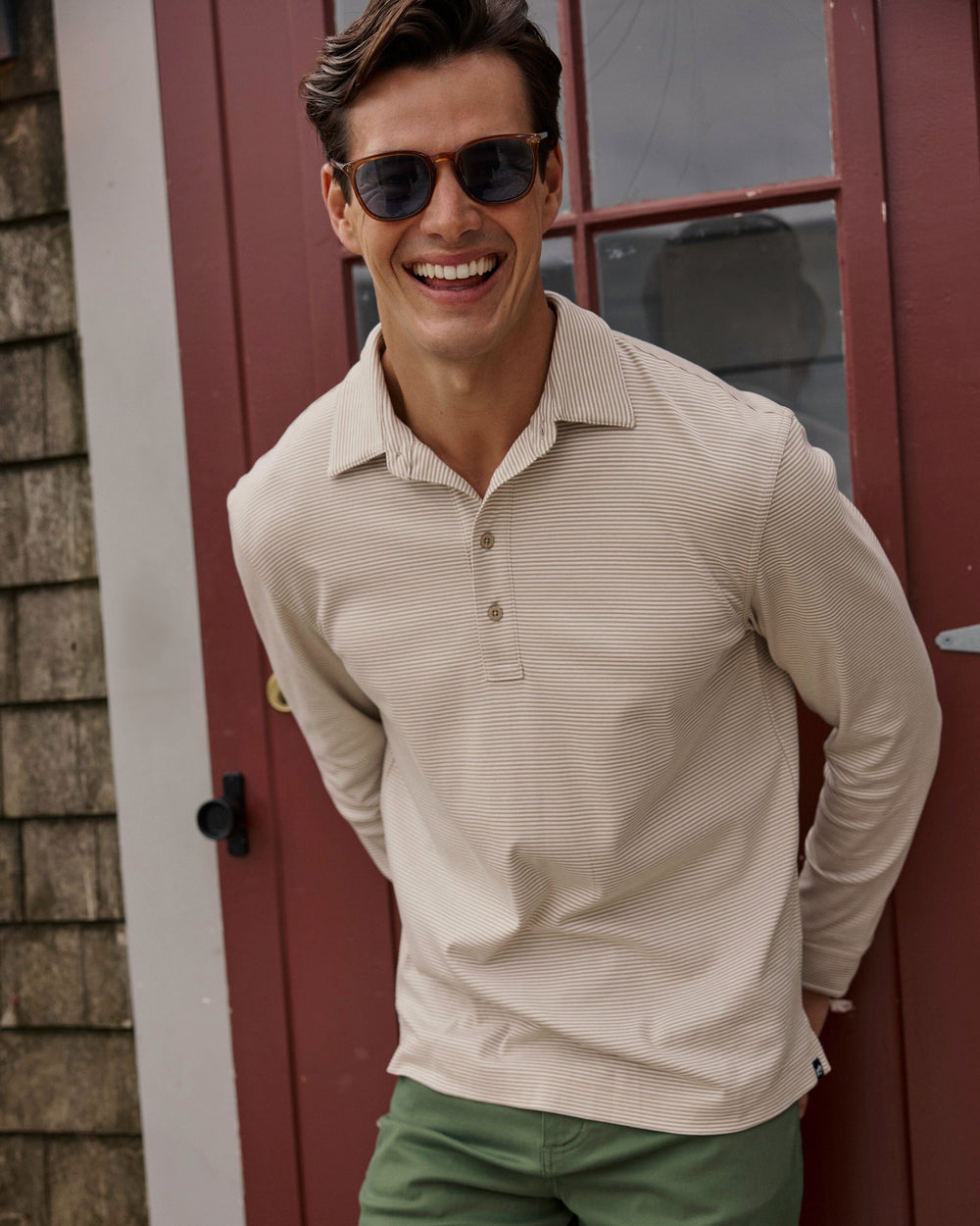 The lifestyle view of the Southern Tide Sandy Cay Long Sleeve Knit Polo by Southern Tide - Sandstone Khaki