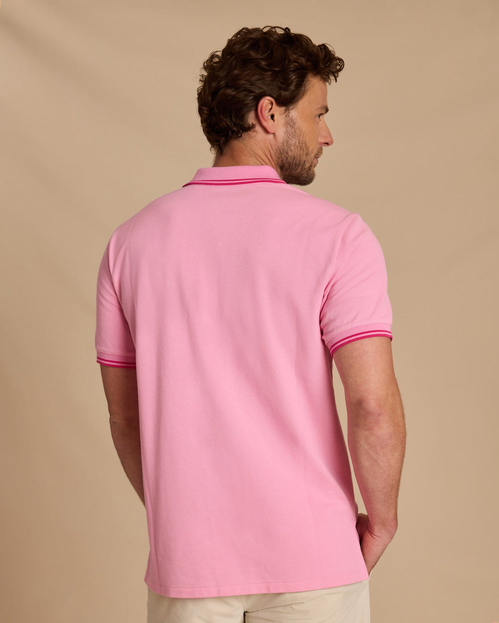 The back view of the Southern Tide Skipjack Coastal Breeze® Pique Polo by Southern Tide - Begonia Pink