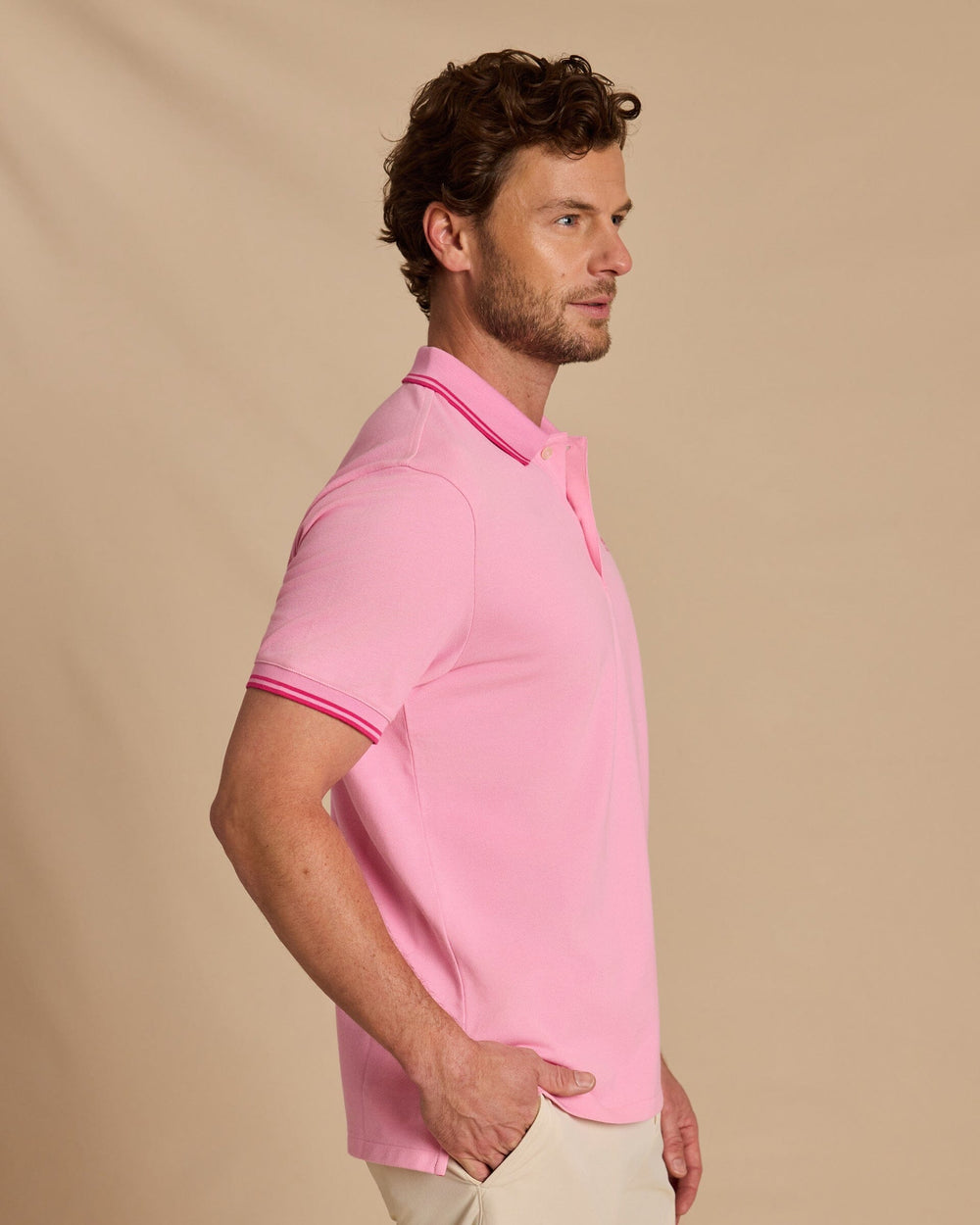The side view of the Southern Tide Skipjack Coastal Breeze® Pique Polo by Southern Tide - Begonia Pink
