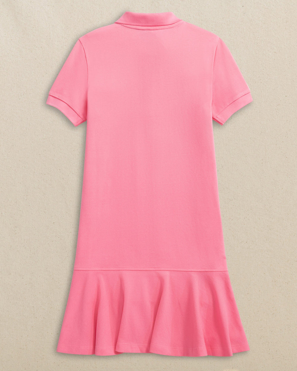 The back view of the Southern Tide Skipjack Dropwaist Polo Dress by Southern Tide - Sea Pink