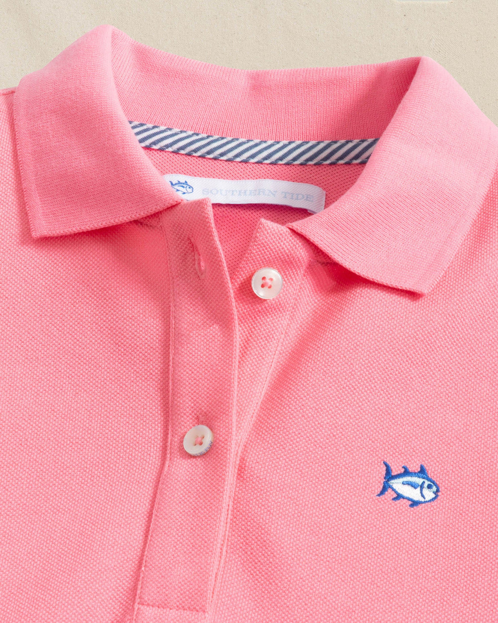 The detail view of the Southern Tide Skipjack Dropwaist Polo Dress by Southern Tide - Sea Pink