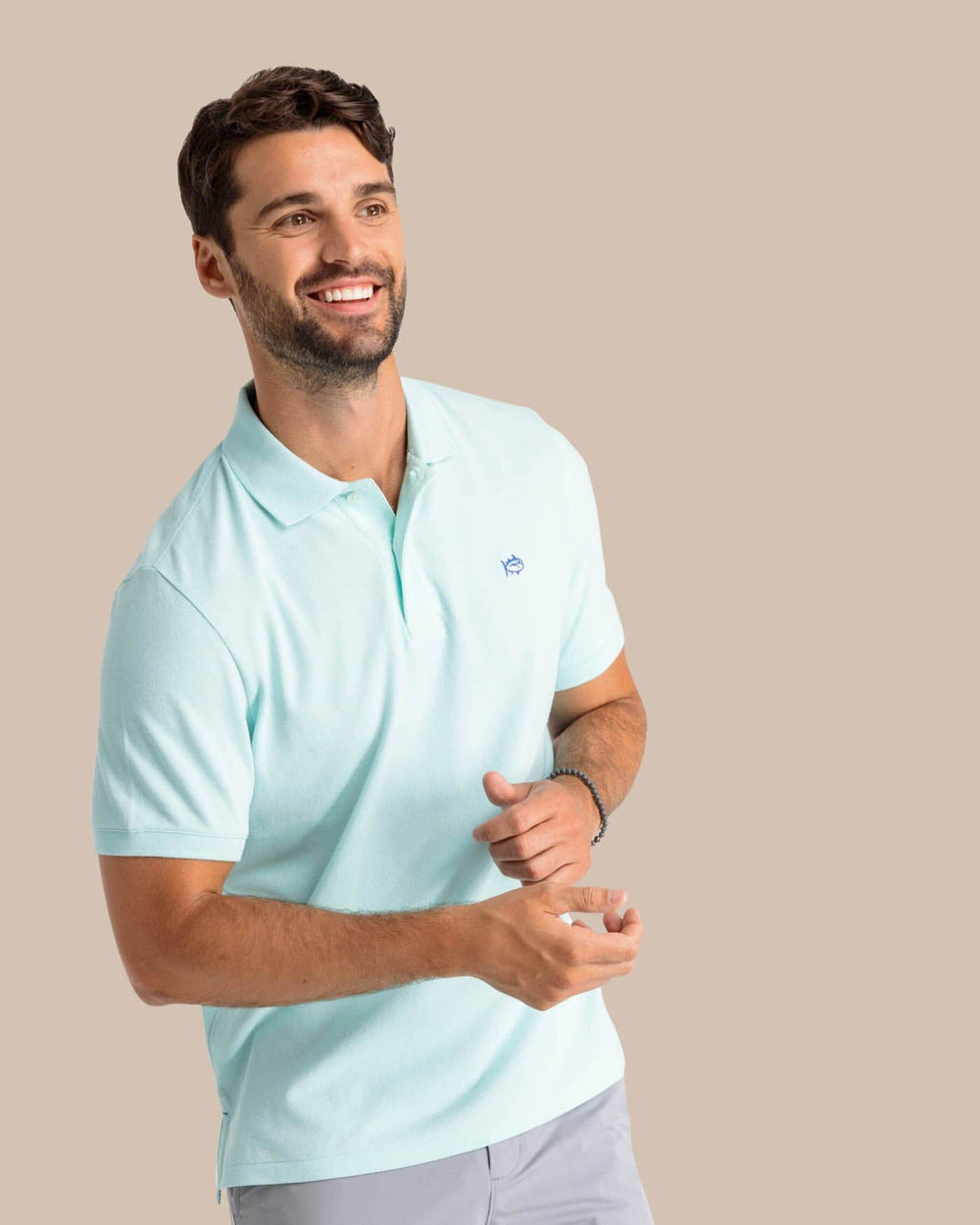 The model front view of the Men's New Skipjack Polo Shirt by Southern Tide - Baltic Teal